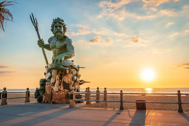 King Neptune statue on the Virginia Beach oceanfront at sunset